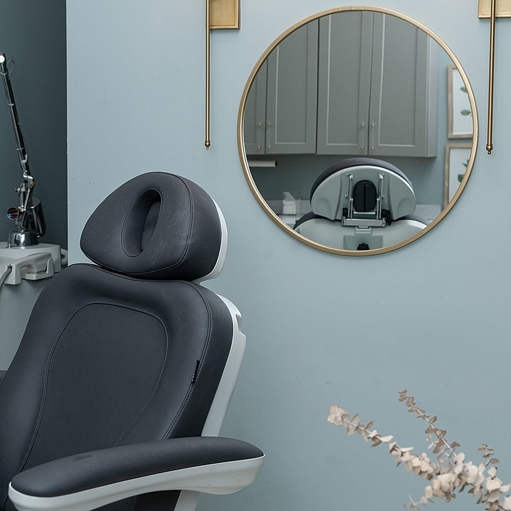 Dental chair with mirror in modern office.