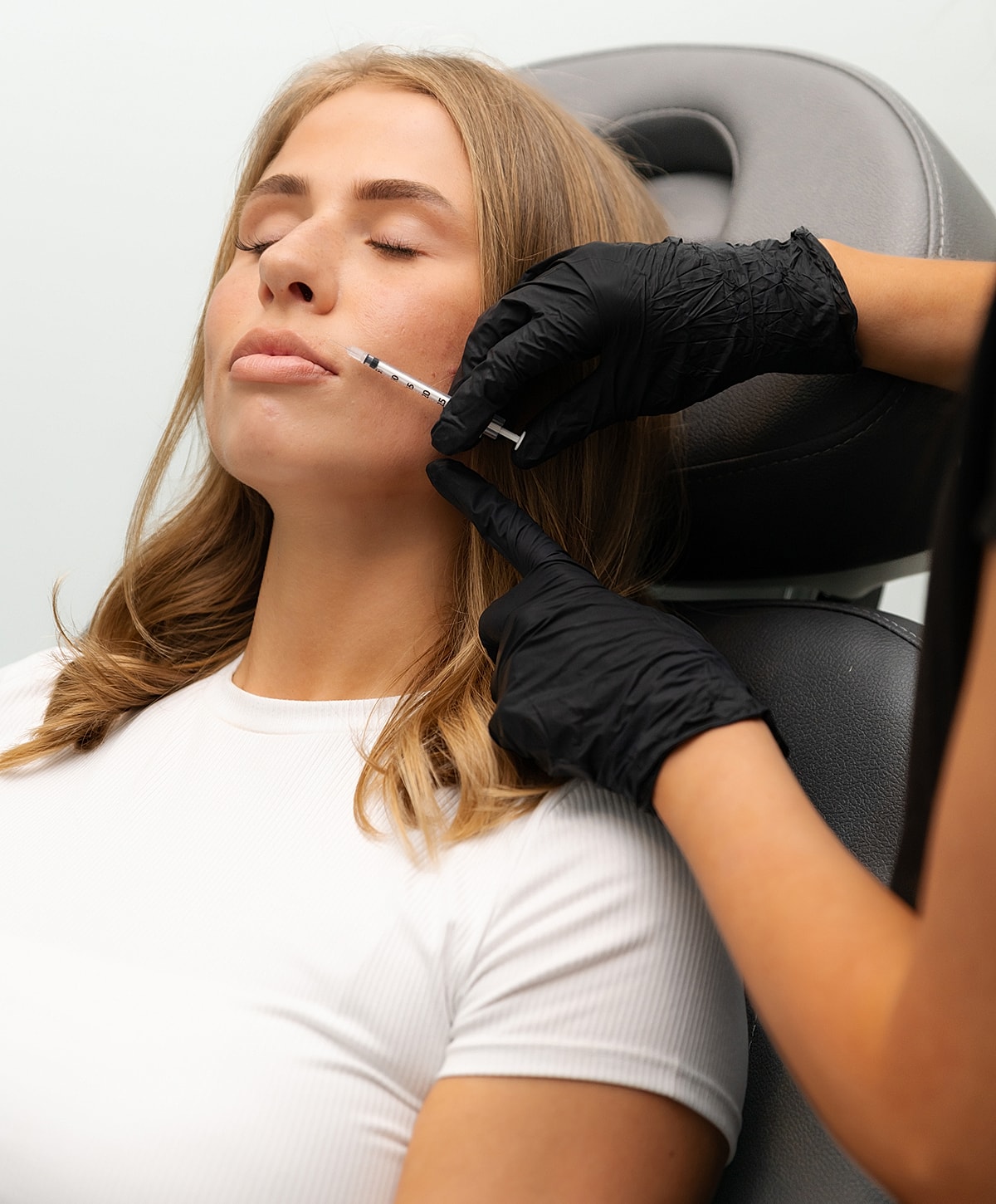 Woman receiving beauty treatment with needle.