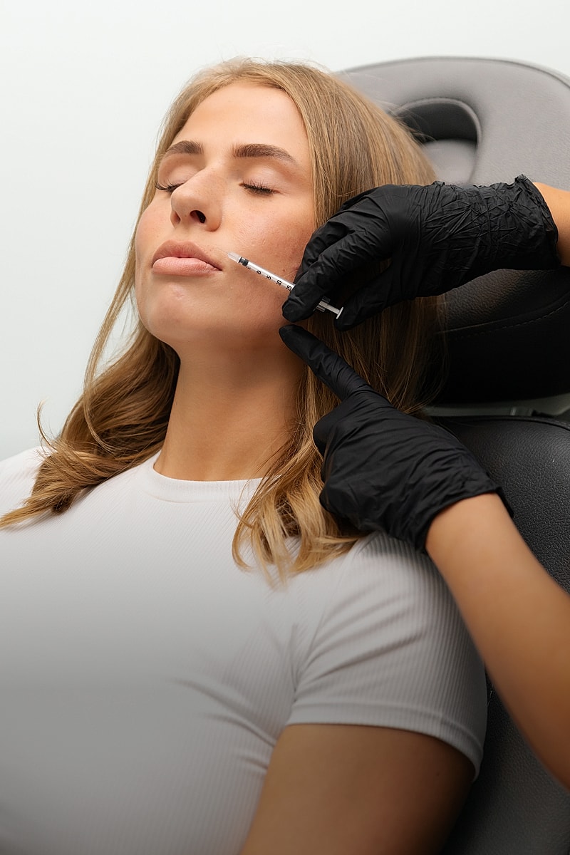 Woman receiving cosmetic injection in clinic.