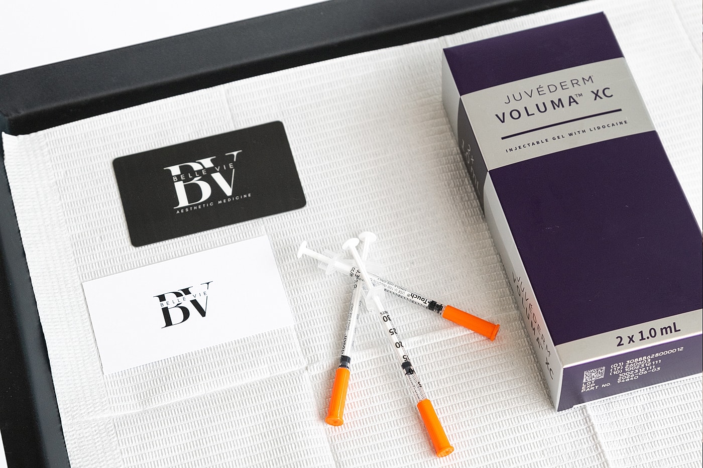 Juvederm Voluma packaging and syringes on surface