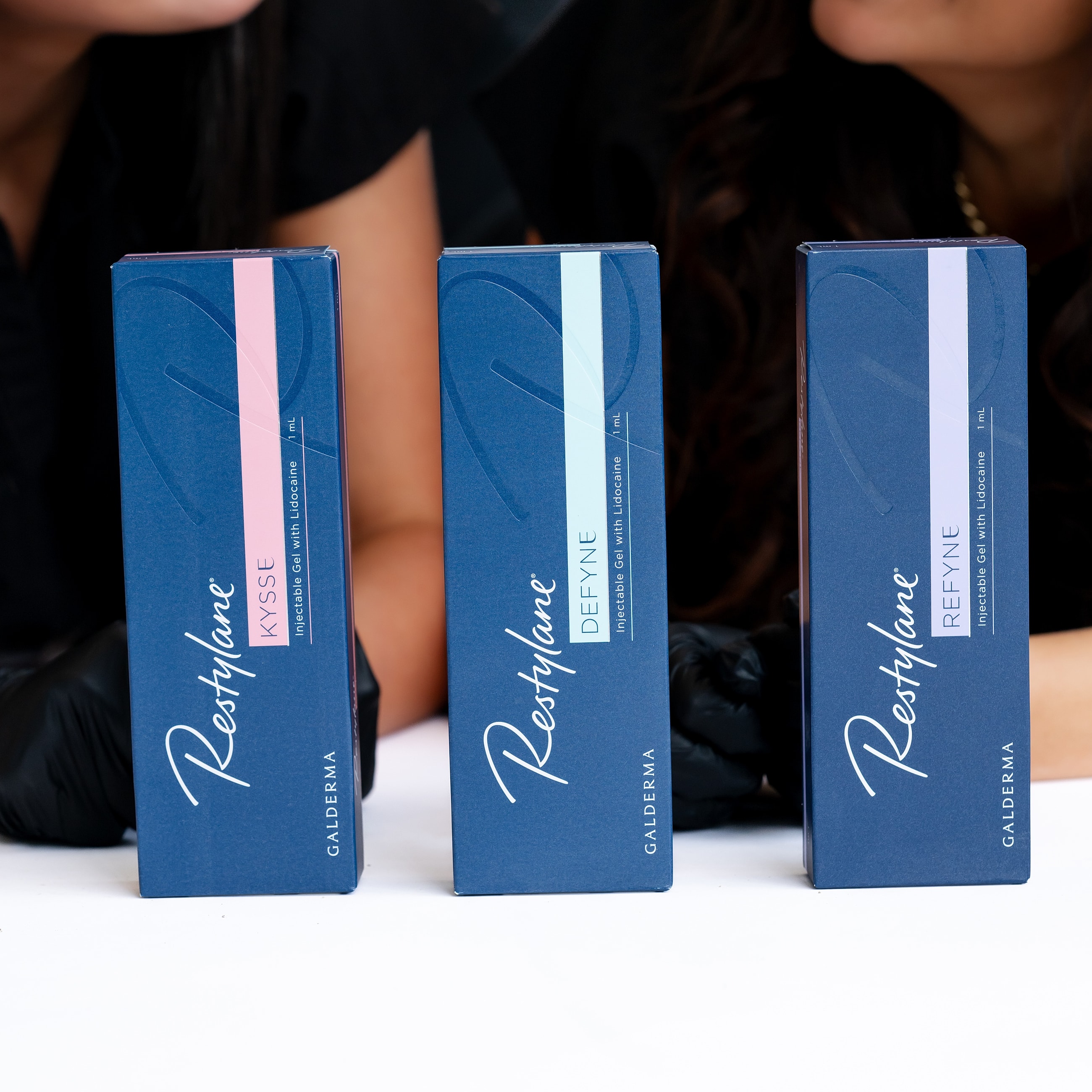 Restylane lip filler products displayed on table.