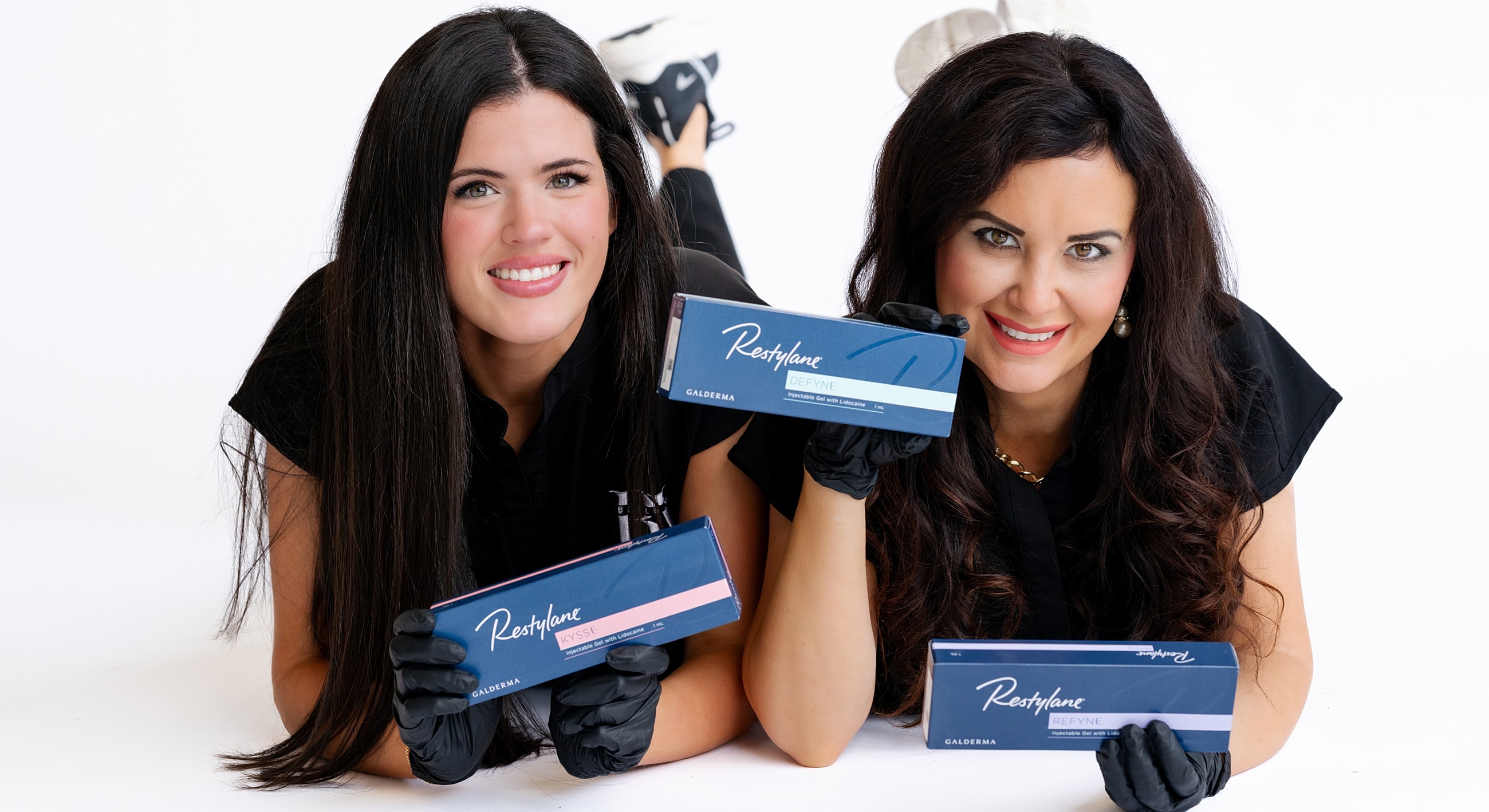 Two women promoting Restylane products together.